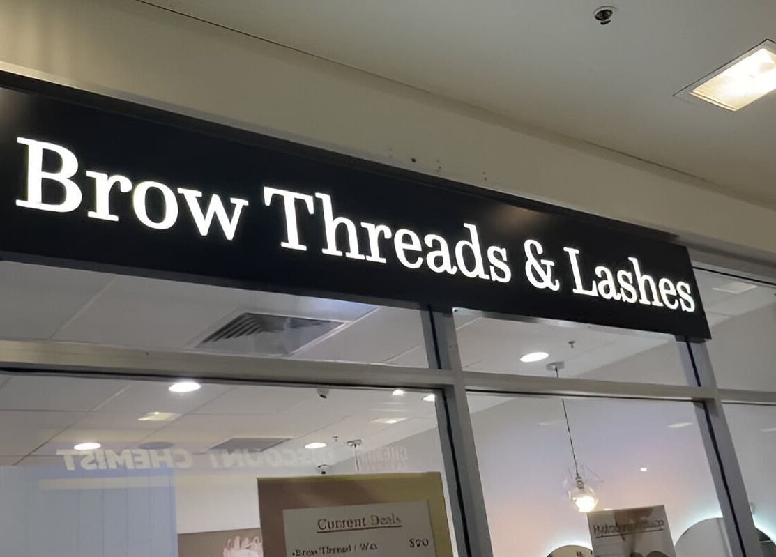 Brow Threads & Lashes signage at Jetty Road, Glenelg, South Australia, AU, showcasing a modern beauty venue.