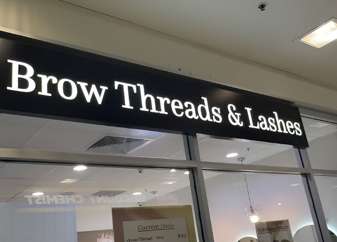 Brow Threads & Lashes signage at Jetty Road, Glenelg, South Australia, AU, showcasing a modern beauty venue.