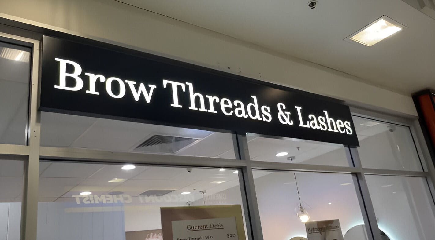 Brow Threads & Lashes signage at Jetty Road, Glenelg, South Australia, AU, showcasing a modern beauty venue.