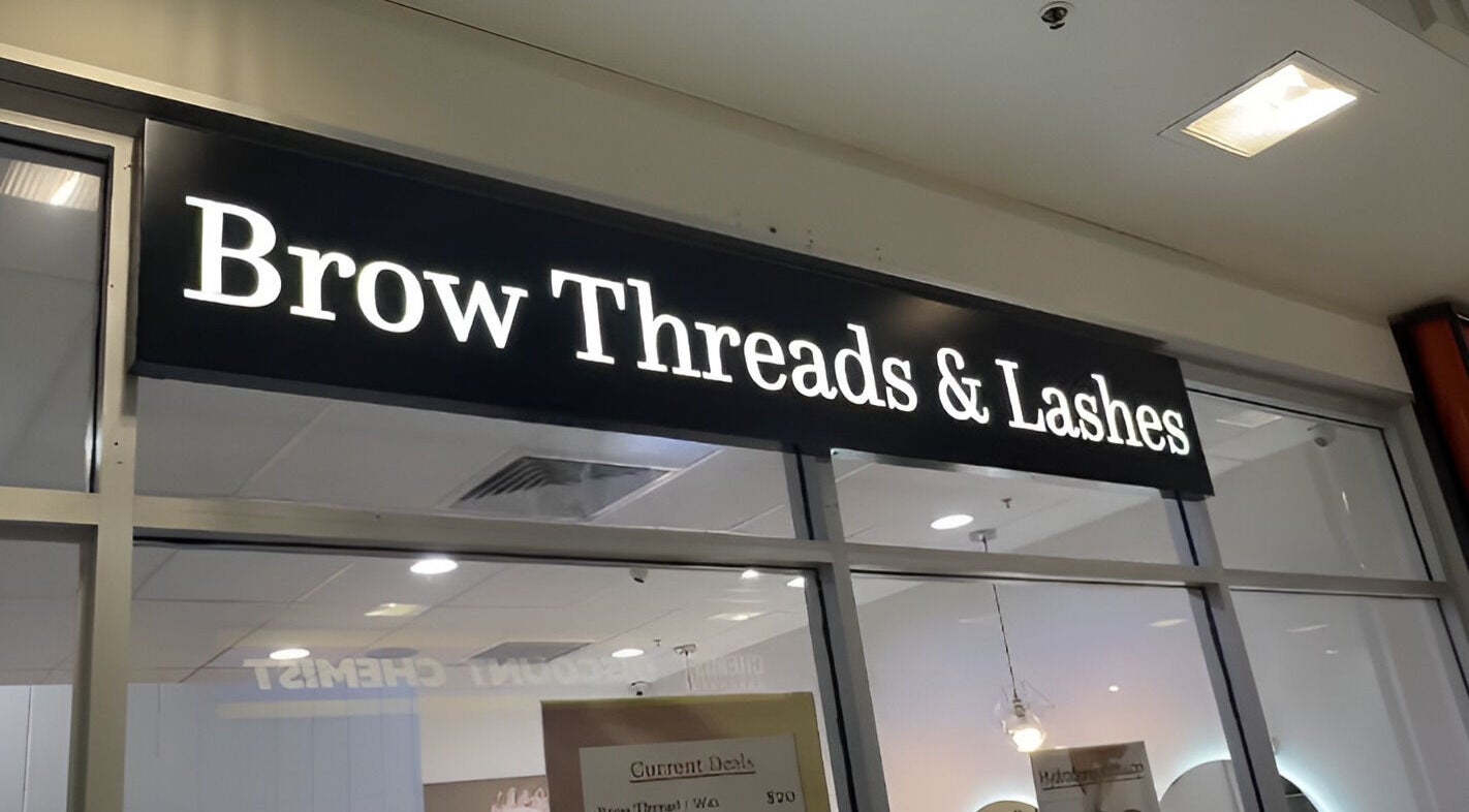 Brow Threads & Lashes signage at Jetty Road, Glenelg, South Australia, AU, showcasing a modern beauty venue.