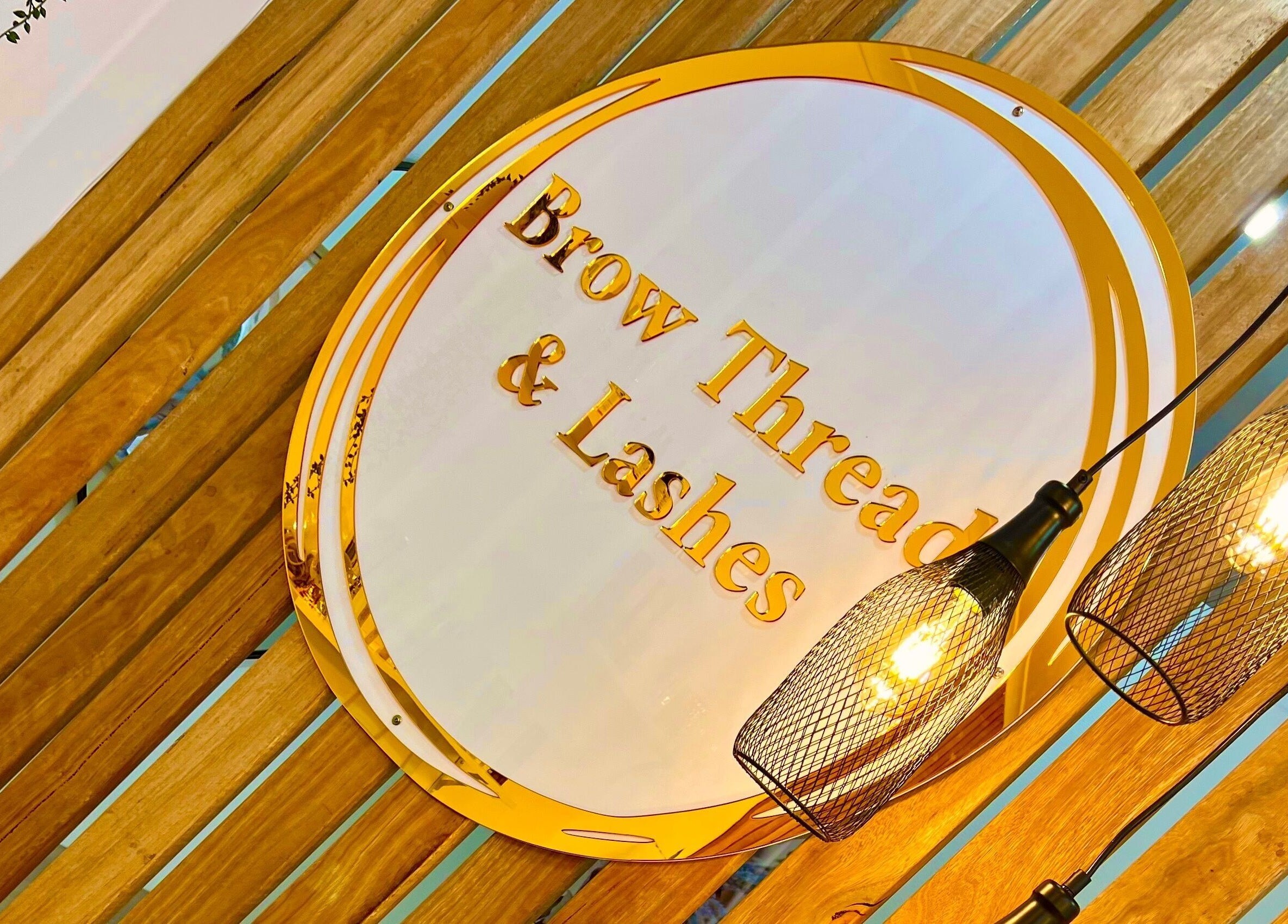Brow Threads & Lashes sign with warm lighting at Jetty Road, Glenelg, South Australia, AU.
