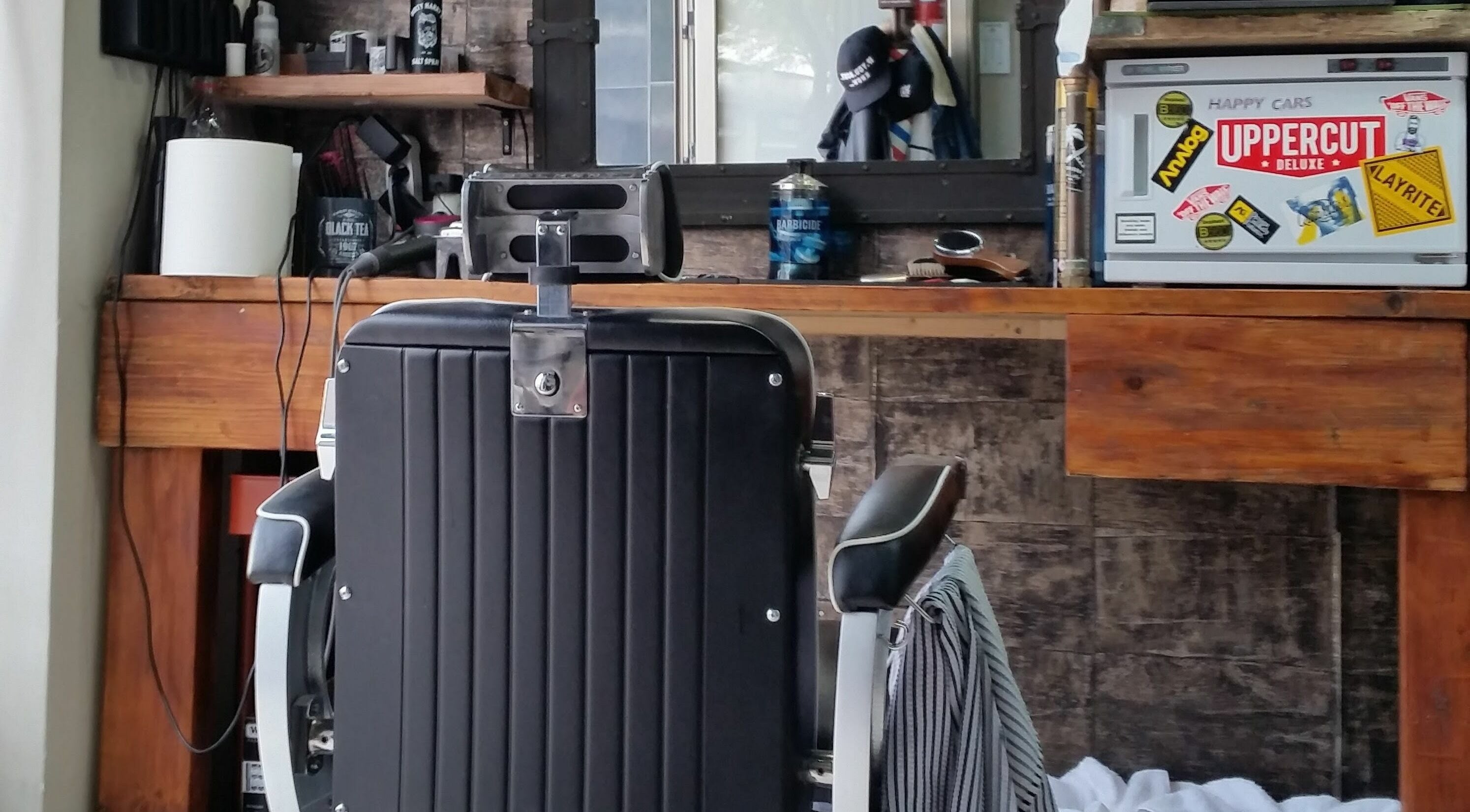 Interior of Uppercuts Barbershop Puerto Banus in Marbella, Andalucía, ES with a vintage barber chair.