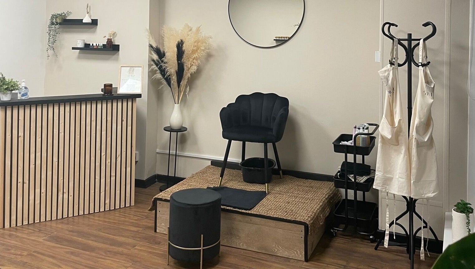 Cozy interior of Studio 11 Nails and Beauty, Oakdale Caerphilly, Wales, GB. Features chair, podium, and decor.