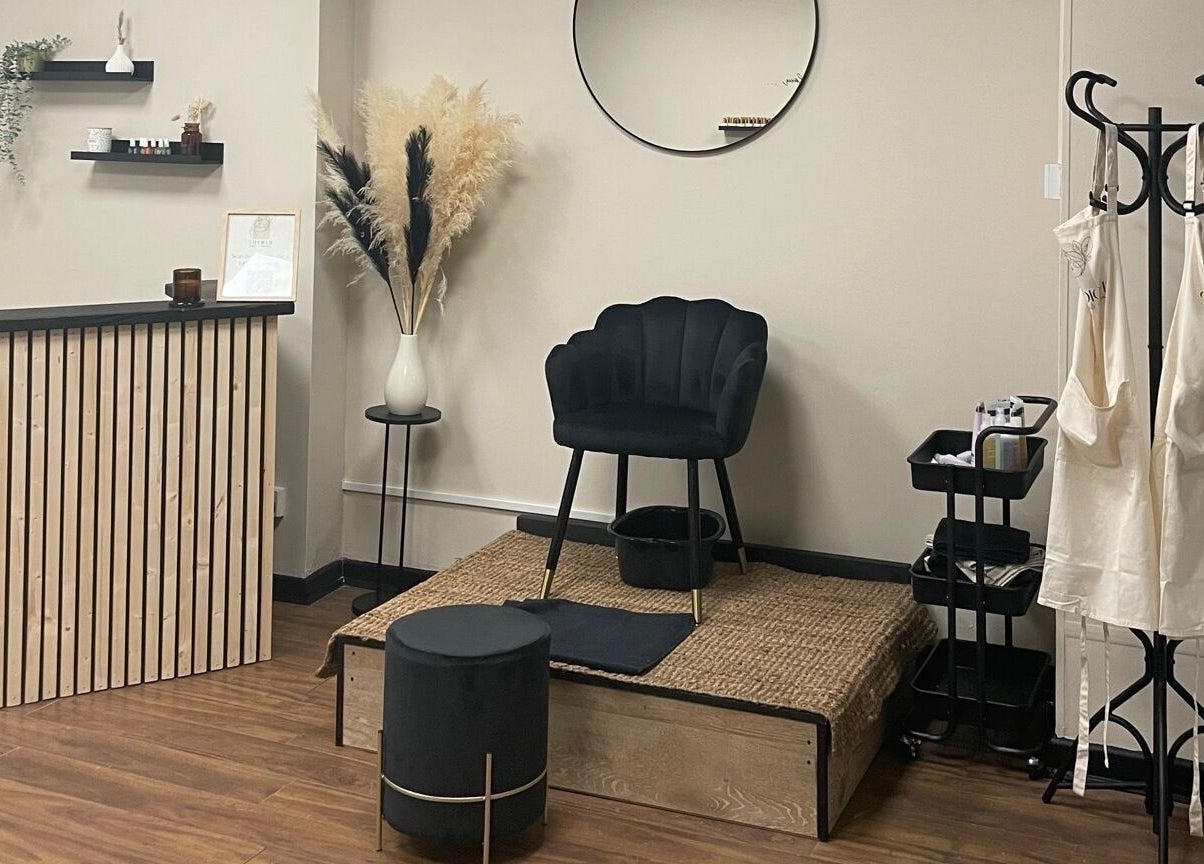 Cozy interior of Studio 11 Nails and Beauty, Oakdale Caerphilly, Wales, GB. Features chair, podium, and decor.