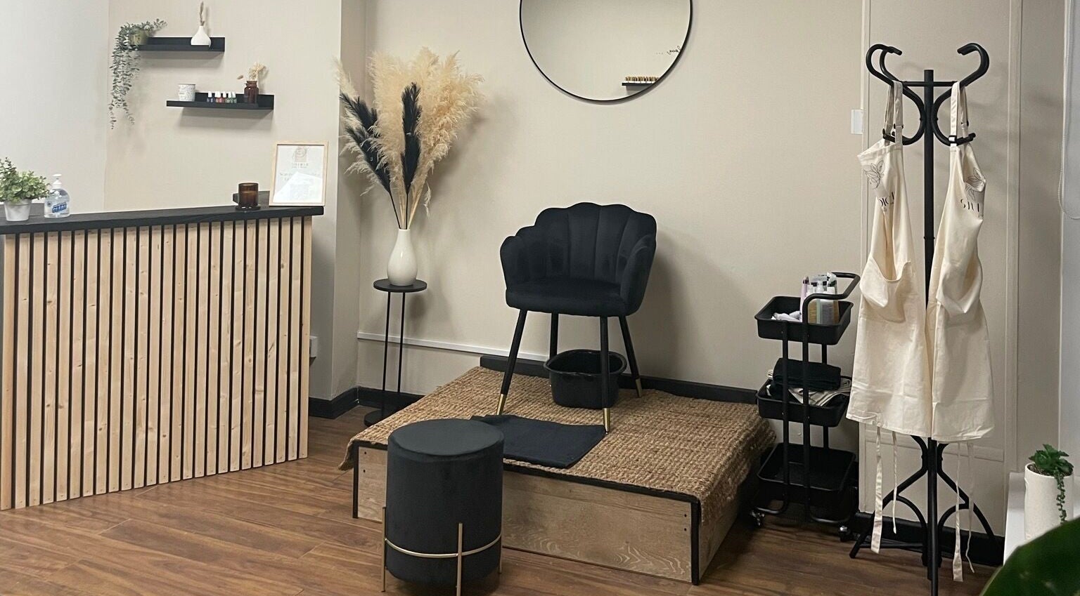 Cozy interior of Studio 11 Nails and Beauty, Oakdale Caerphilly, Wales, GB. Features chair, podium, and decor.