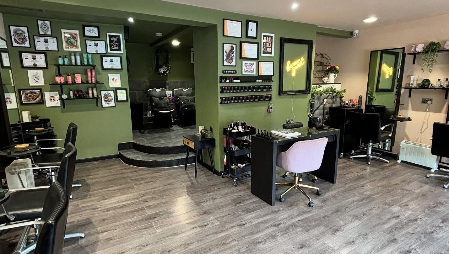 Interior of Crompton & Co salon in Heywood, England, showcasing elegant styling stations and wall art.