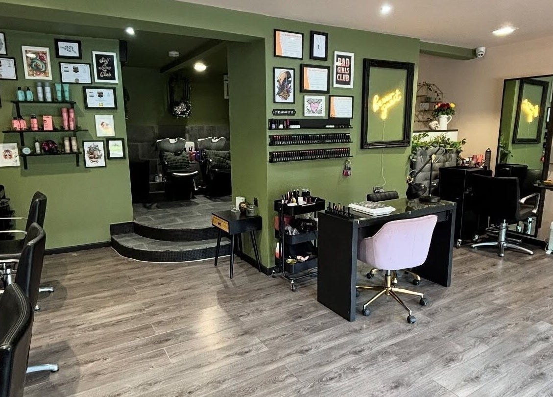Interior of Crompton & Co salon in Heywood, England, showcasing elegant styling stations and wall art.