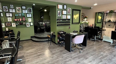 Interior of Crompton & Co salon in Heywood, England, showcasing elegant styling stations and wall art.