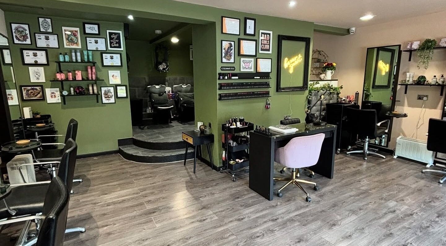 Interior of Crompton & Co salon in Heywood, England, showcasing elegant styling stations and wall art.