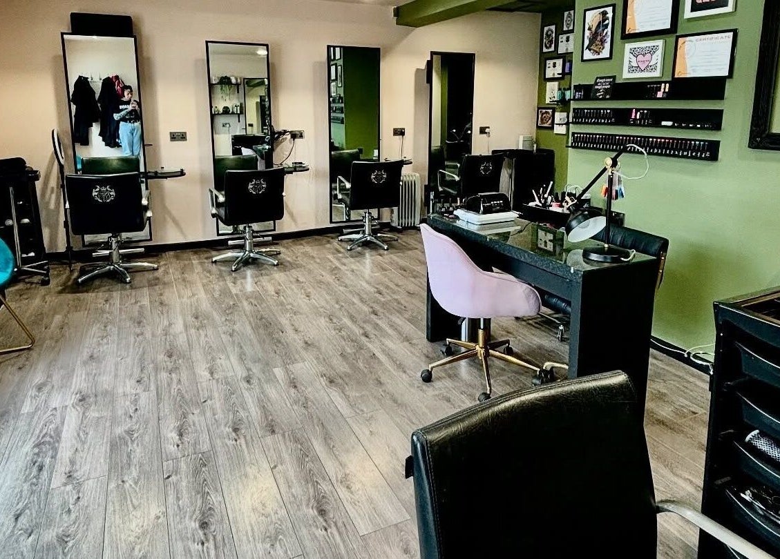 Modern salon interior at Crompton & Co, Heywood, England, GB with stylish chairs and decor.