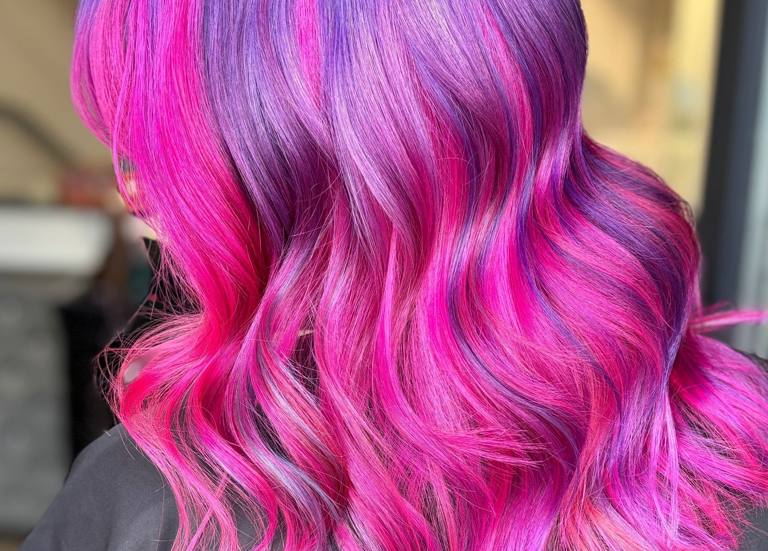 Vibrant pink and purple hair styling at Crompton & Co, Heywood, England, GB.