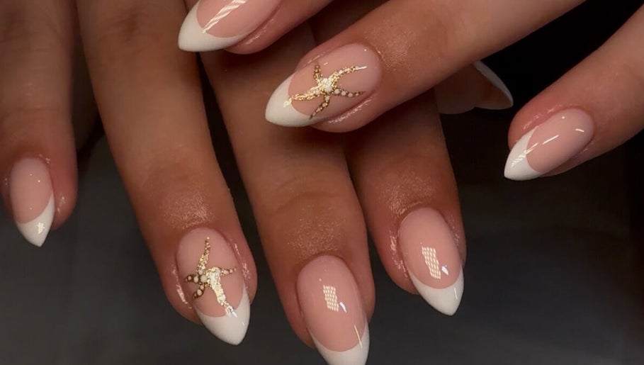 Stylish French manicure with gold accents at Keep It Cassie, Hucclecote, England, GB.