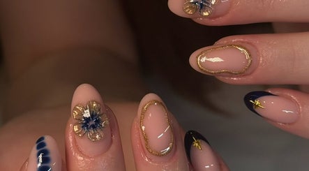 Exquisite nail art with gold and blue designs at Keep It Cassie, Hucclecote, England, GB.