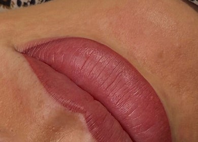 Close-up of lips with pink gloss at Keep It Cassie, Hucclecote, England, GB, showcasing beauty services.