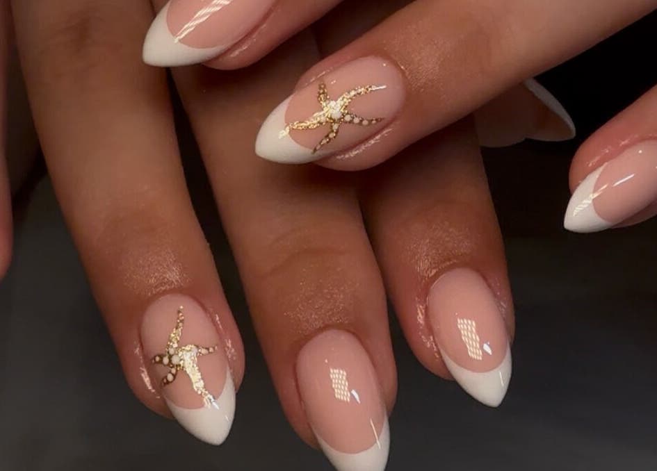 Elegant nail art with French tips and gold accents at Keep It Cassie, Hucclecote, England, GB.