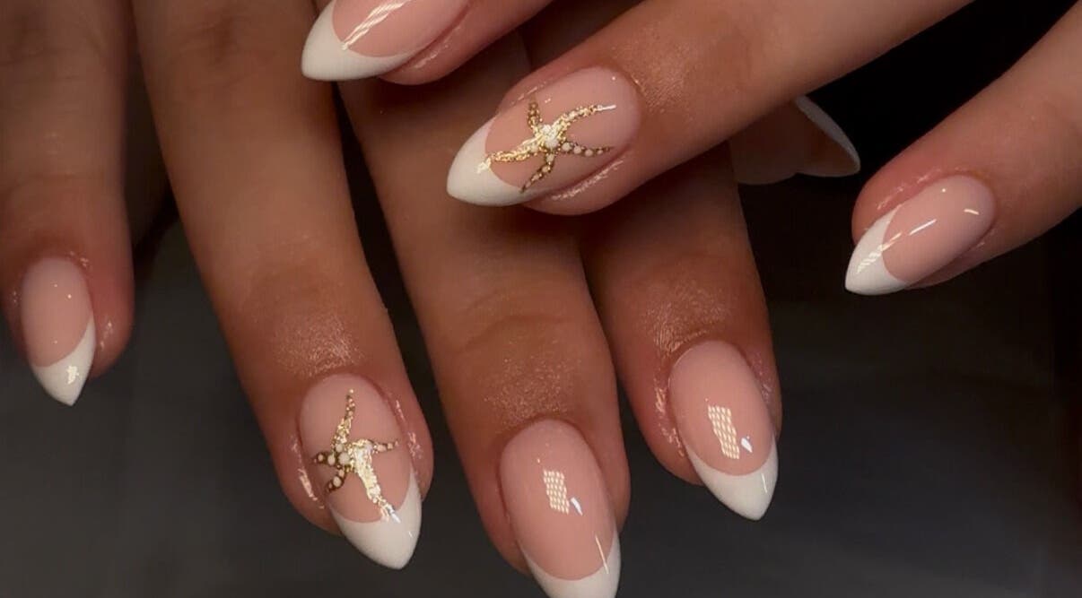 Elegant nail art with French tips and gold accents at Keep It Cassie, Hucclecote, England, GB.