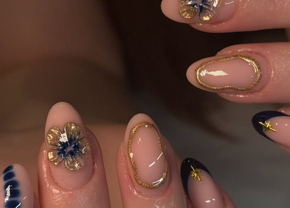 Elegant nail art with floral accents at Keep It Cassie, Hucclecote, England, GB, showcasing intricate gold details.