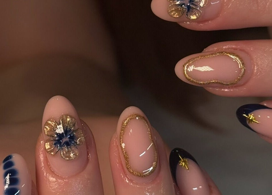 Elegant nail art with floral accents at Keep It Cassie, Hucclecote, England, GB, showcasing intricate gold details.