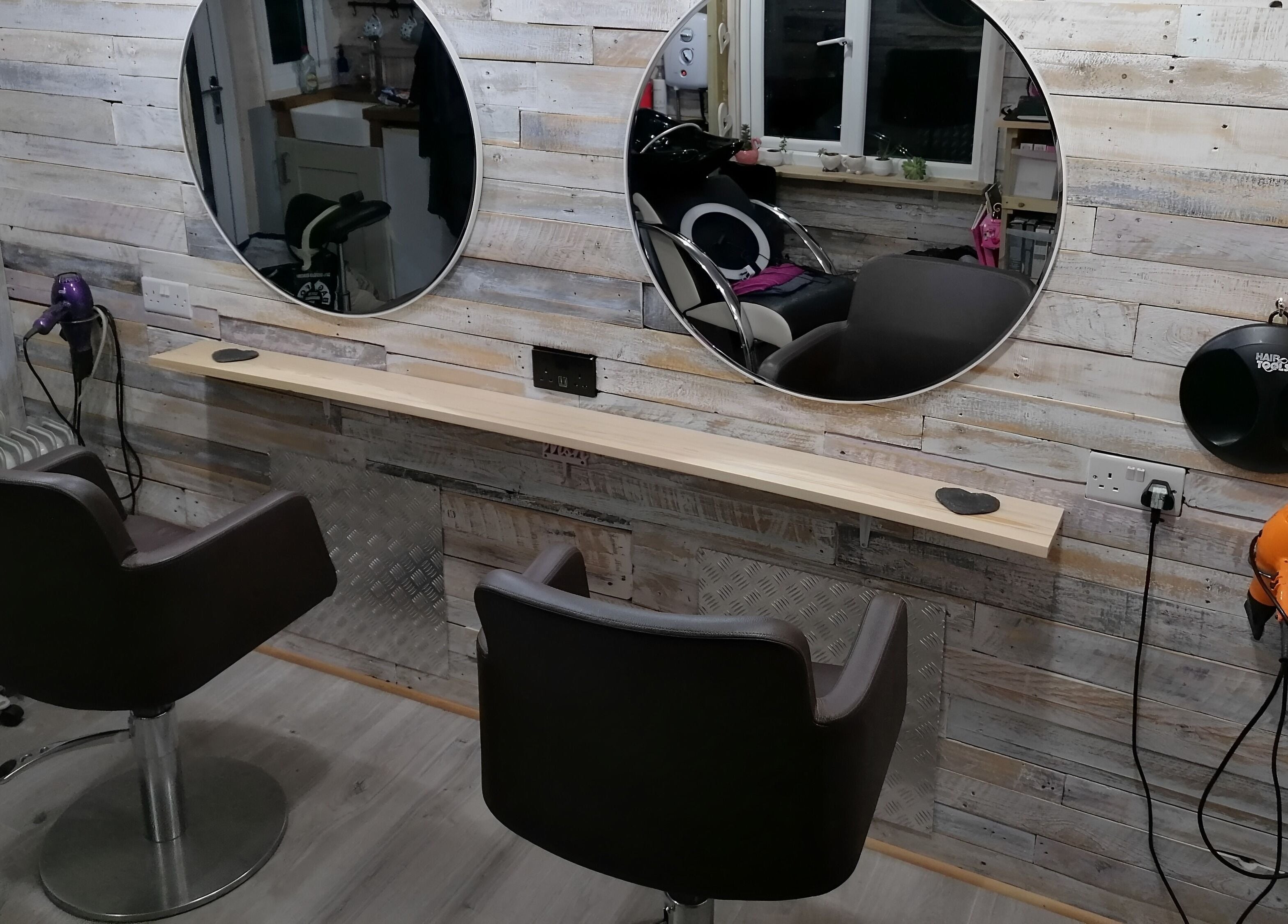 Chic styling stations at The Colourbox Hair Salon, Indian Queens, England, GB, highlighting modern design.
