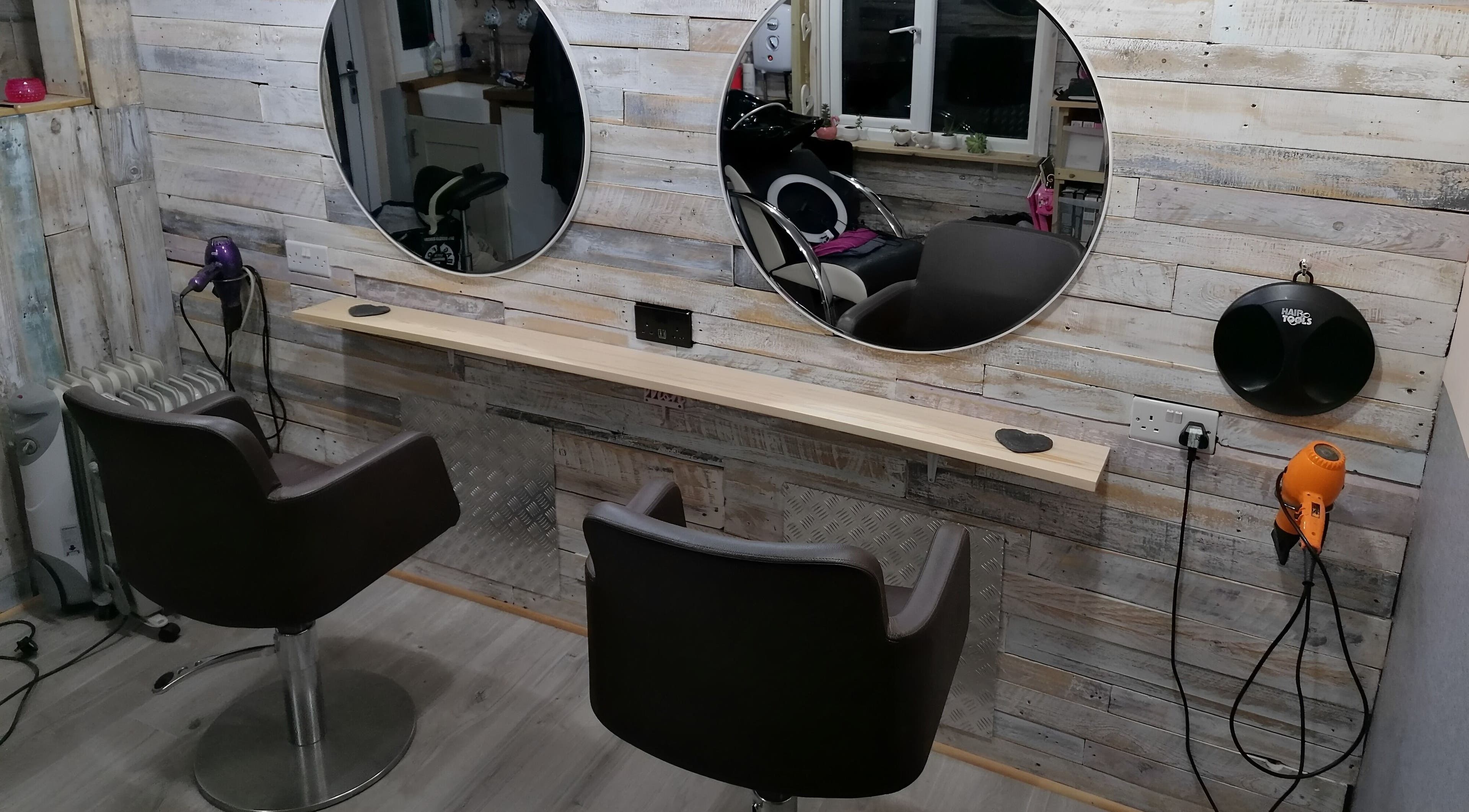 Chic styling stations at The Colourbox Hair Salon, Indian Queens, England, GB, highlighting modern design.