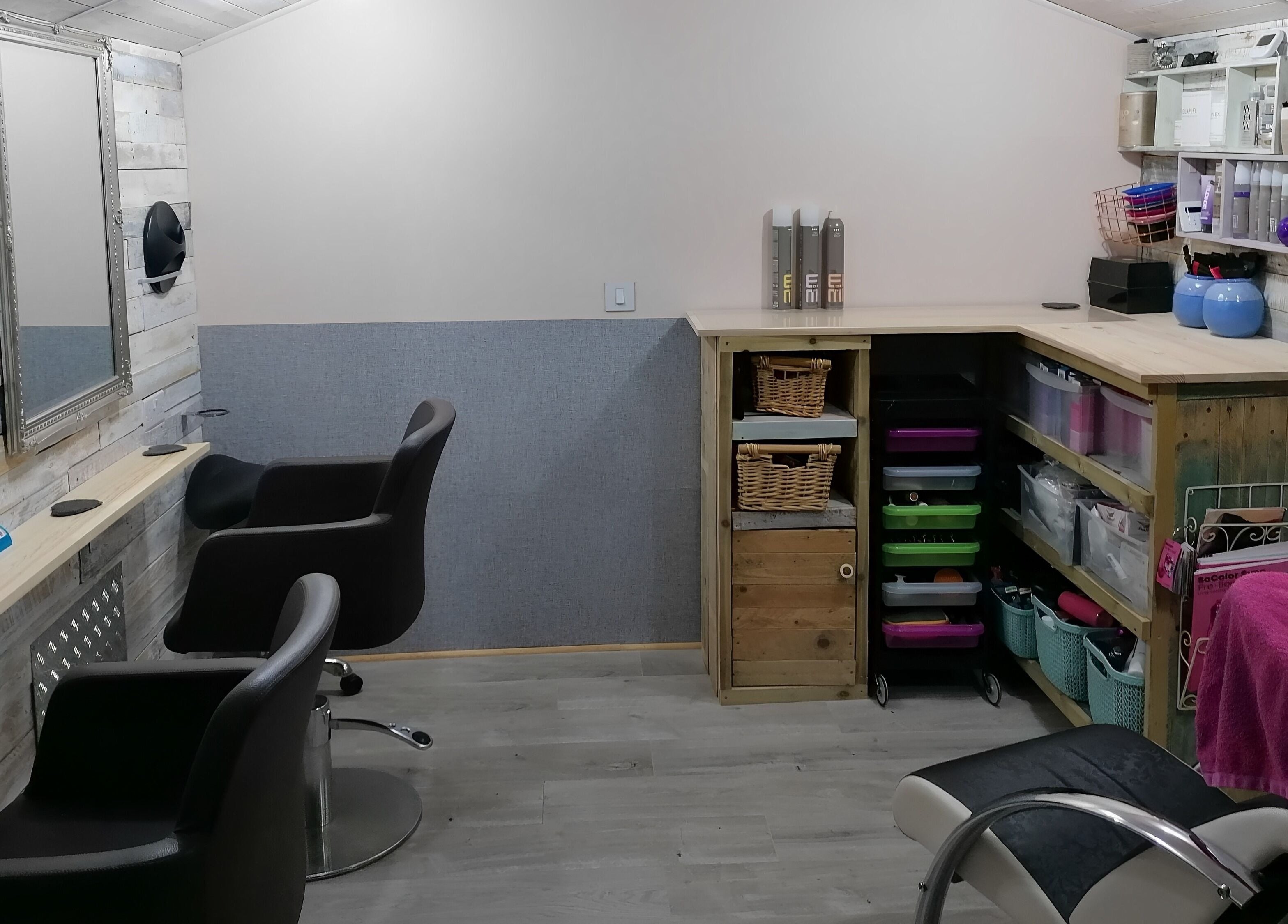 Cozy styling area at The Colourbox Hair Salon, Indian Queens, England, GB with rustic decor and modern chairs.