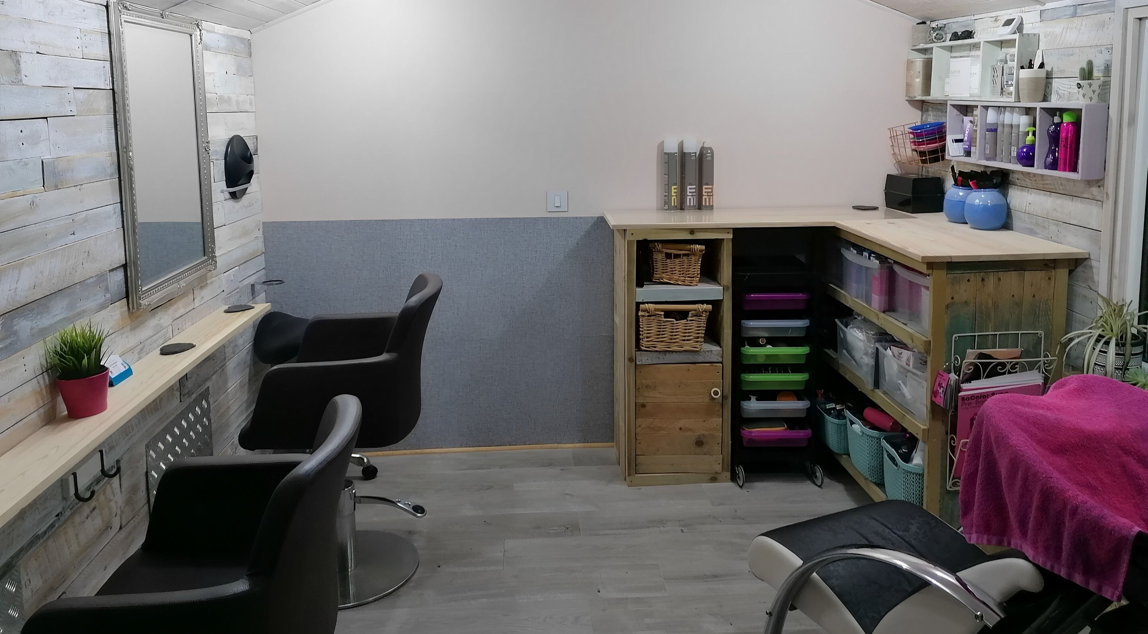 Cozy styling area at The Colourbox Hair Salon, Indian Queens, England, GB with rustic decor and modern chairs.
