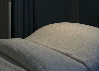 Luxurious treatment bed at BARE SSKIN, Melbourne, Victoria, AU, offering relaxing wellness experiences.