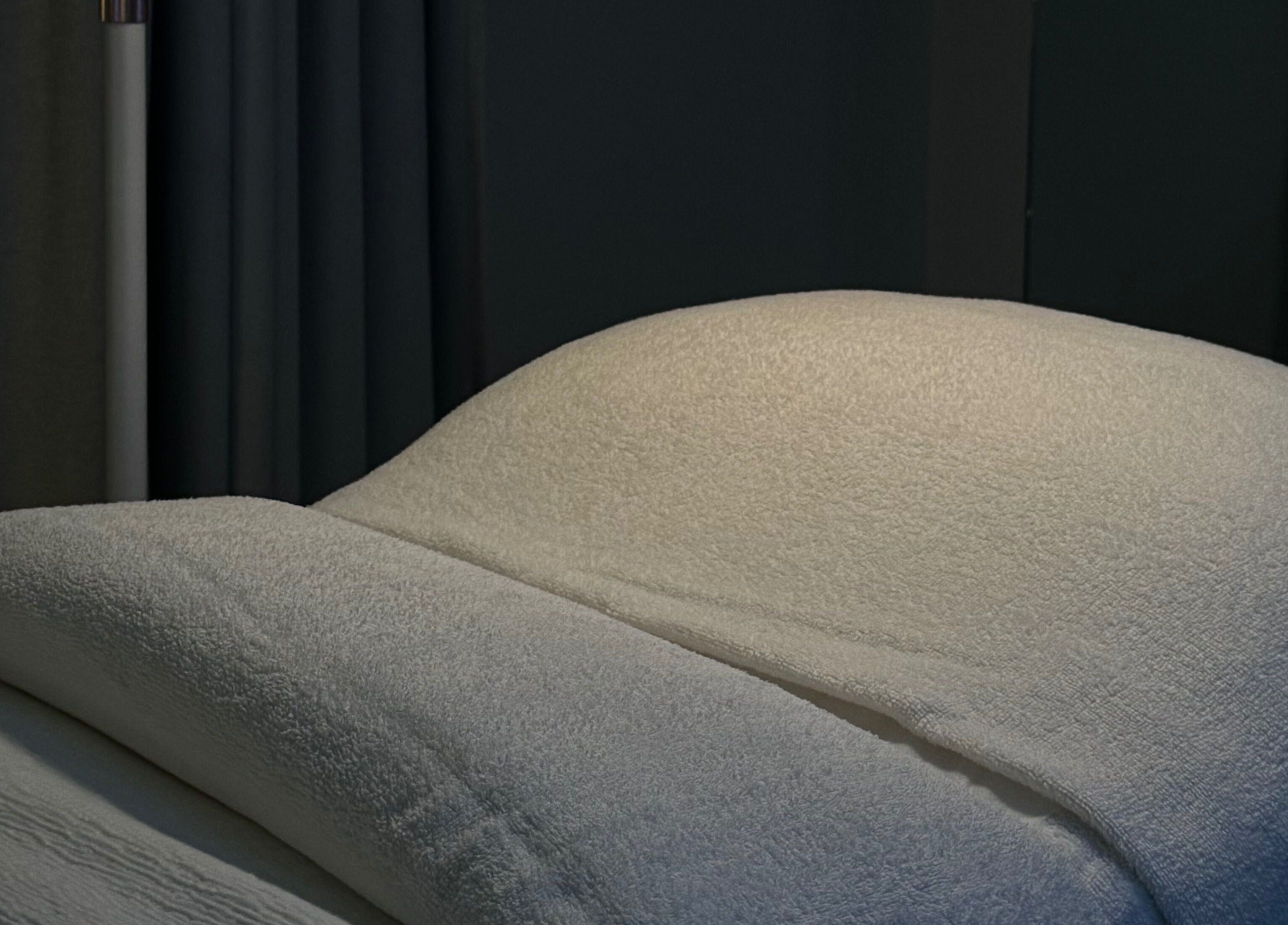 Luxurious treatment bed at BARE SSKIN, Melbourne, Victoria, AU, offering relaxing wellness experiences.