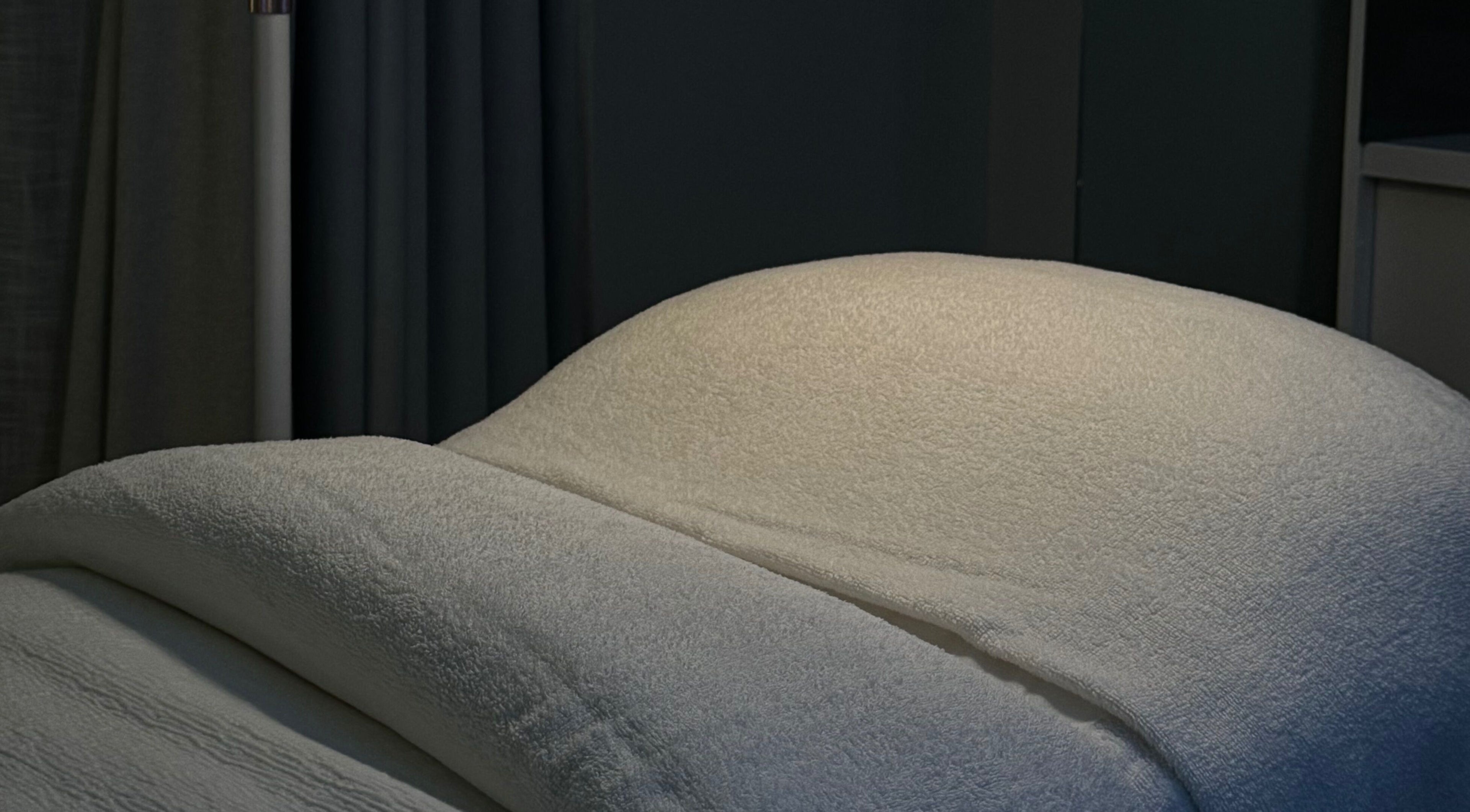Luxurious treatment bed at BARE SSKIN, Melbourne, Victoria, AU, offering relaxing wellness experiences.