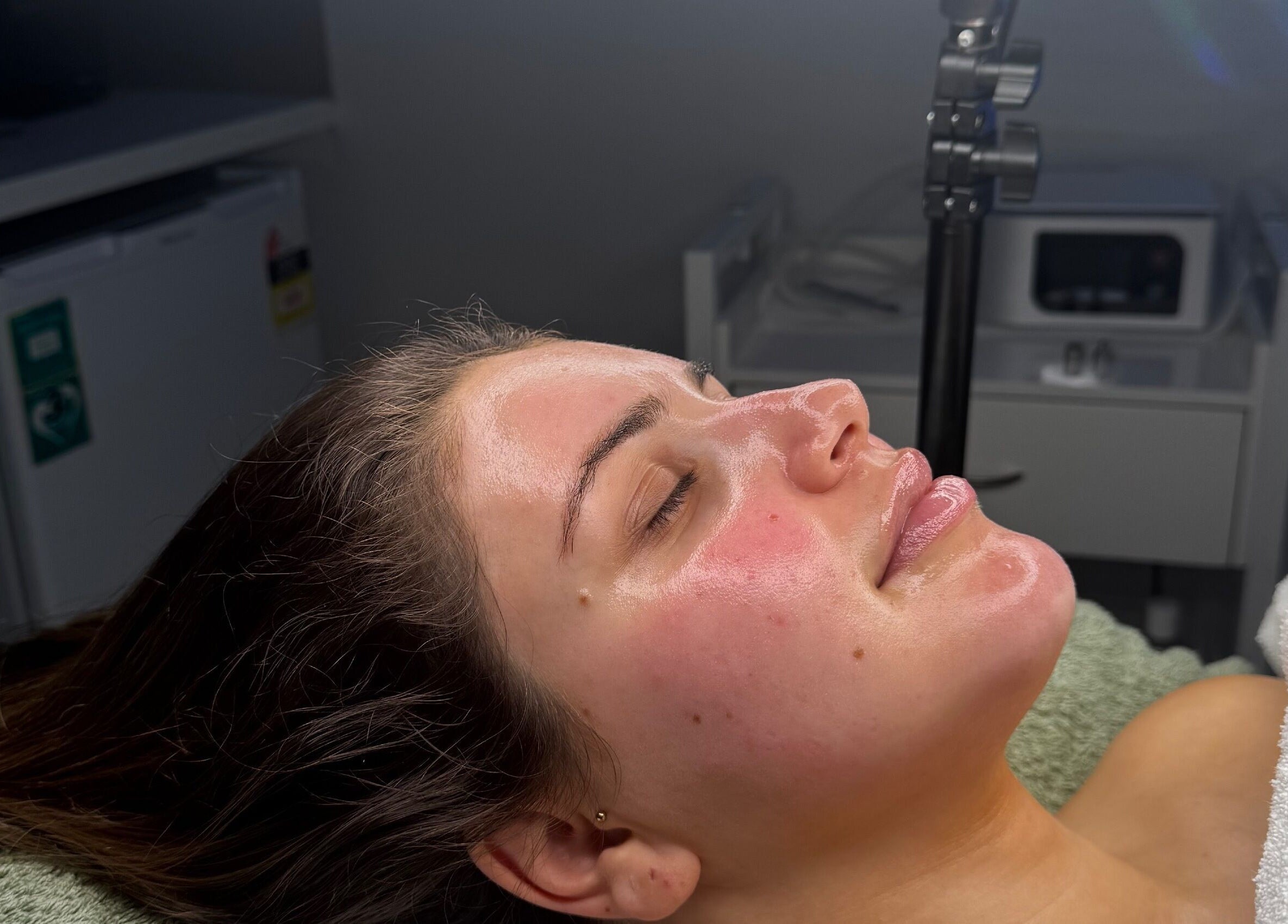 Client receiving facial treatment at BARE SSKIN in Melbourne, Victoria, AU, showcasing rejuvenated skin.