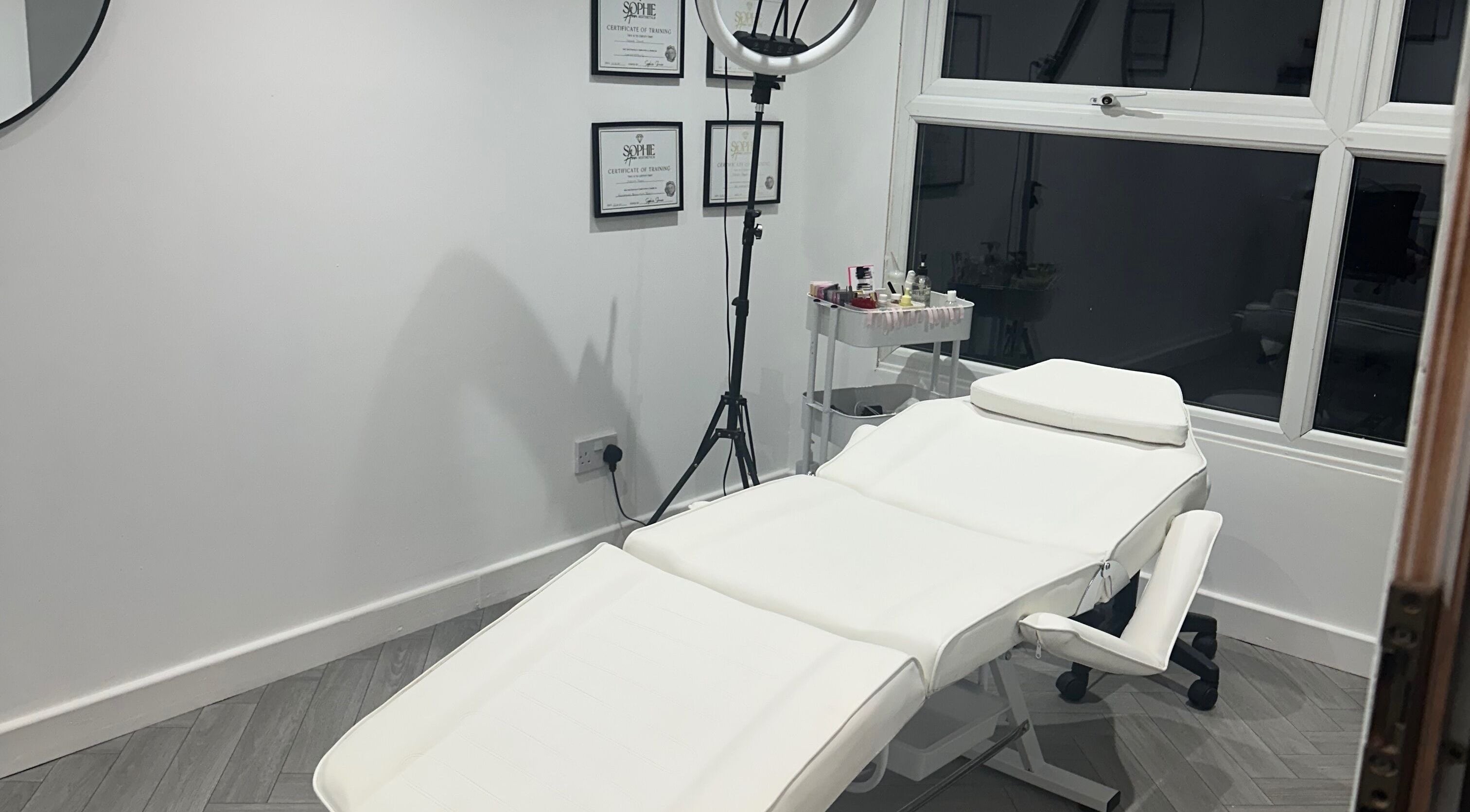 Luxury treatment room at Beauty & Aesthetics By Maisie, Hindley, England, GB, featuring a plush white recliner.