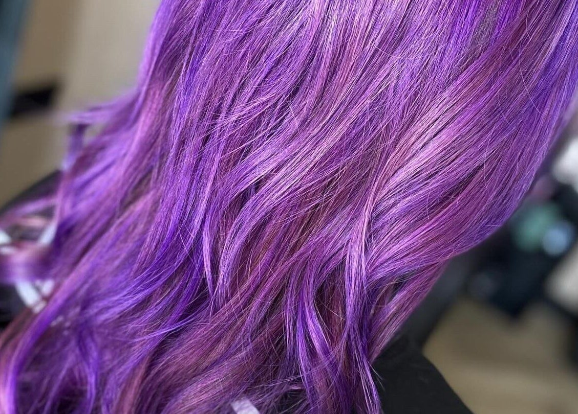 Vibrant purple hair styled in waves at FabYouLocks, Motherwell, Scotland, GB.