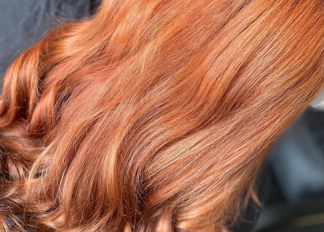 Vibrant ginger hair styled at FabYouLocks, Motherwell, Scotland, GB salon. Perfect shine and care.