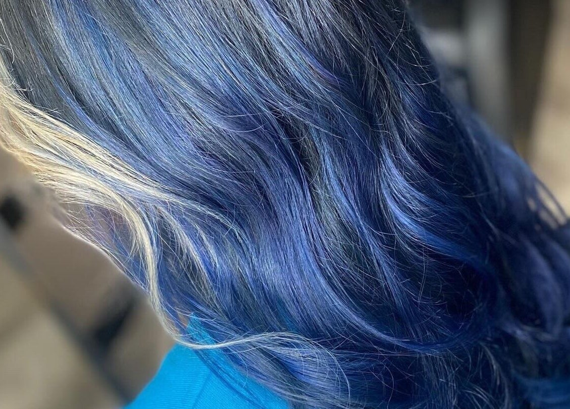 Vibrant blue hair styling at FabYouLocks in Motherwell, Scotland, GB, showcasing stunning color and shine.