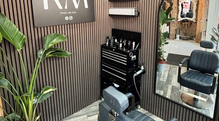 Stylish barber station at RM Barbering, Stockton-on-tees, England, featuring sleek chair and greenery.