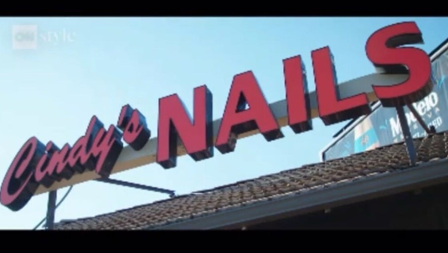 Bold sign of Cindy's Nails in Denver, Colorado, US against a clear blue sky.