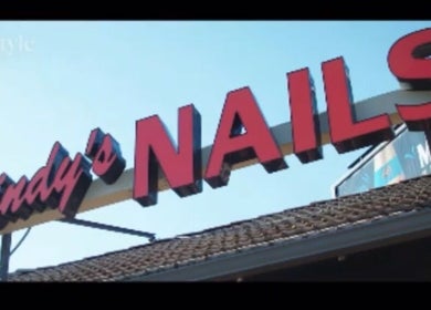 Bold sign of Cindy's Nails in Denver, Colorado, US against a clear blue sky.