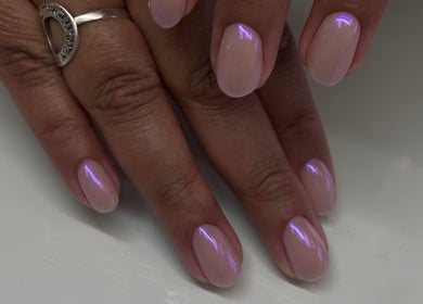 Glistening pink nails with a shimmer finish at Cindy's Nails, Denver, Colorado, US.