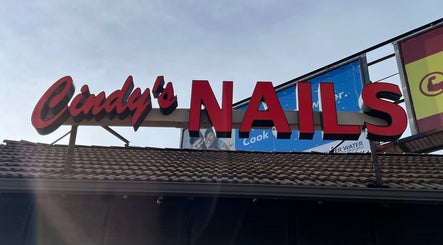 Cindy's Nails rooftop sign in Denver, Colorado, US under a clear sky.