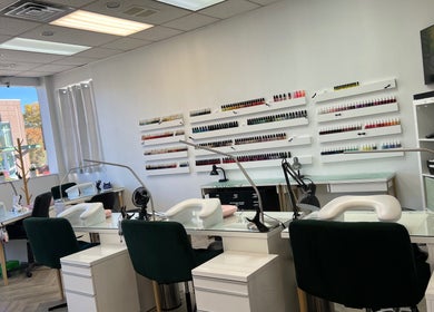 Modern interior of Cindy's Nails in Denver, Colorado, US, showcasing stylish workstations and vibrant nail polish displays.