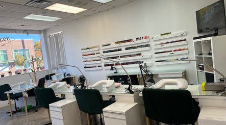 Modern interior of Cindy's Nails in Denver, Colorado, US, showcasing stylish workstations and vibrant nail polish displays.