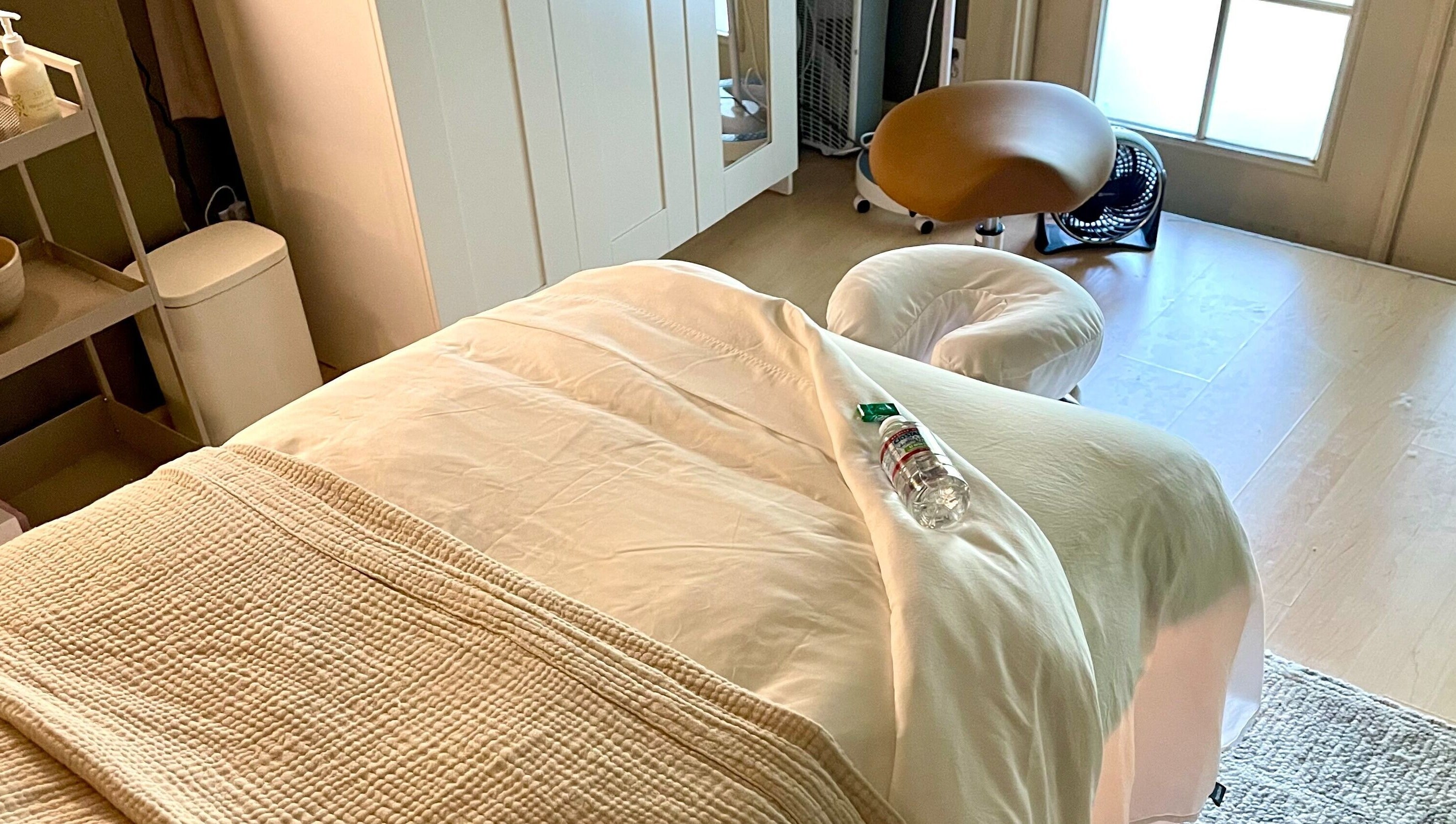 Relaxing massage room at The June Massage and Skin Studio, Monroe, Washington, US, featuring a comfy treatment bed.