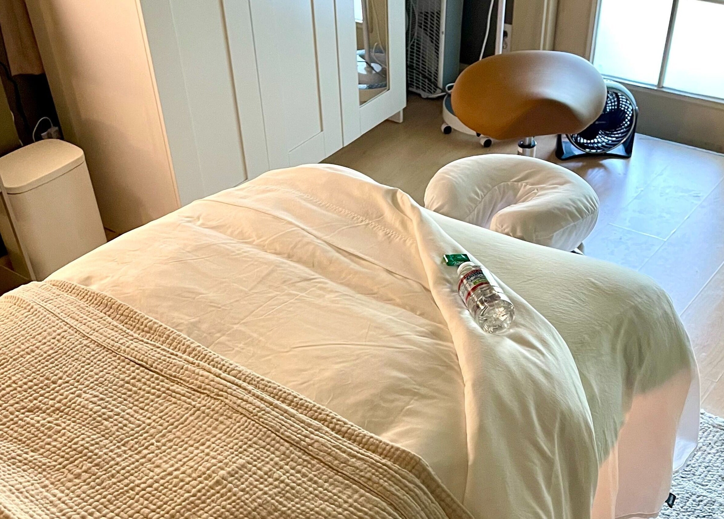 Relaxing massage room at The June Massage and Skin Studio, Monroe, Washington, US, featuring a comfy treatment bed.