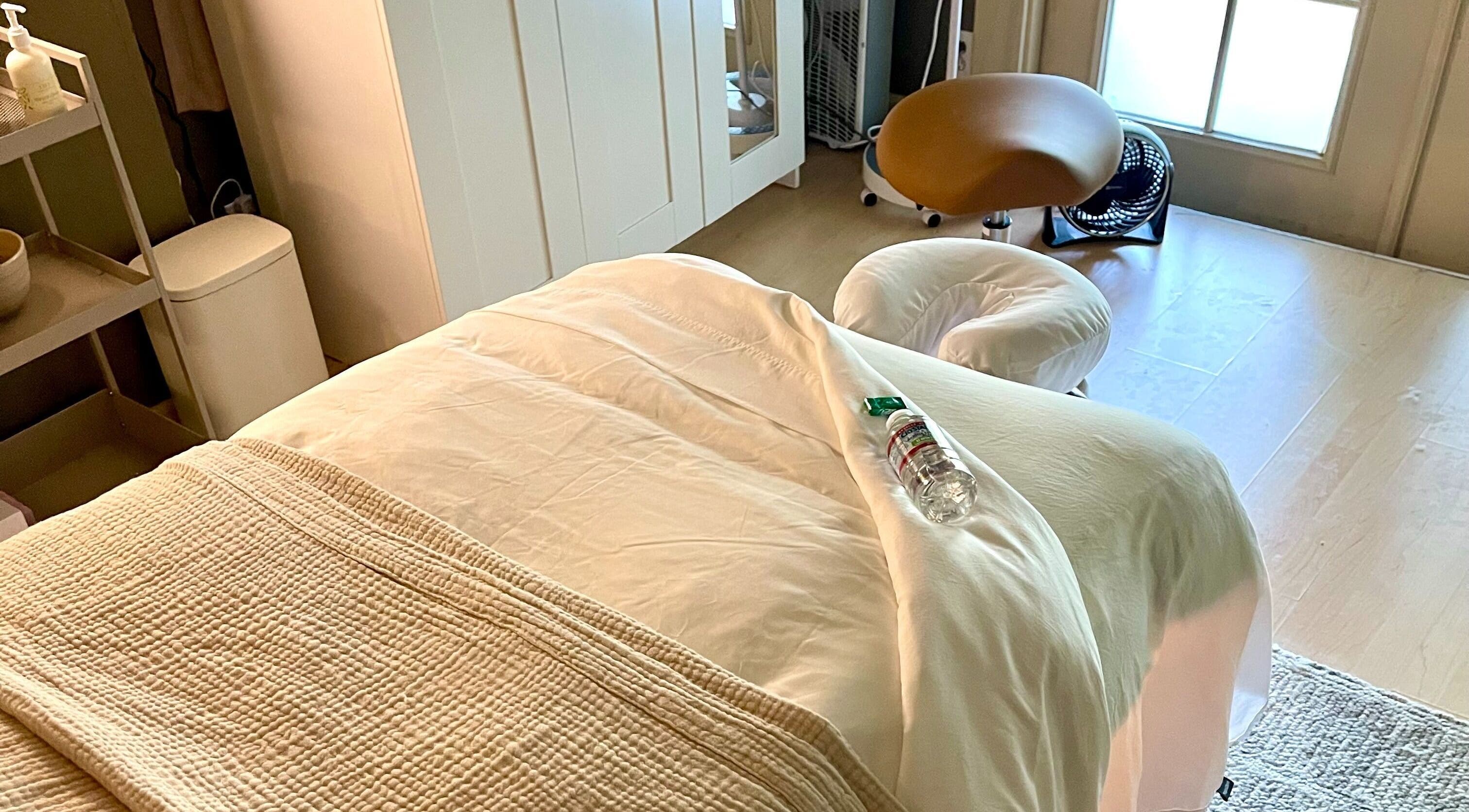 Relaxing massage room at The June Massage and Skin Studio, Monroe, Washington, US, featuring a comfy treatment bed.