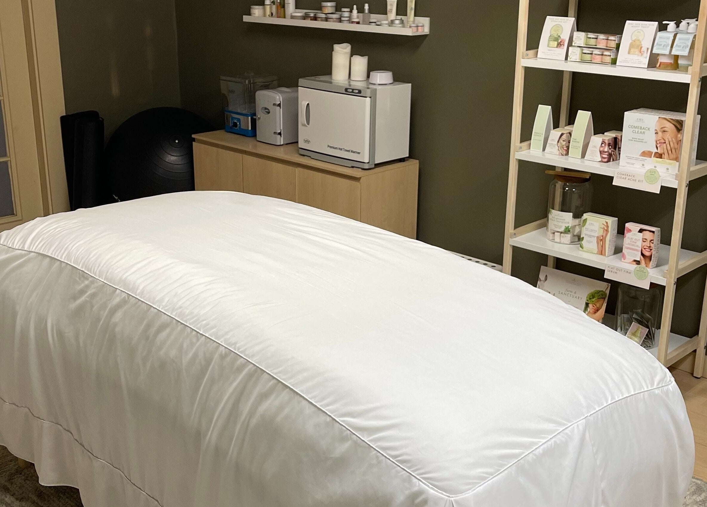 Calming massage room at The June Massage and Skin Studio in Monroe, Washington, US, featuring a treatment bed.