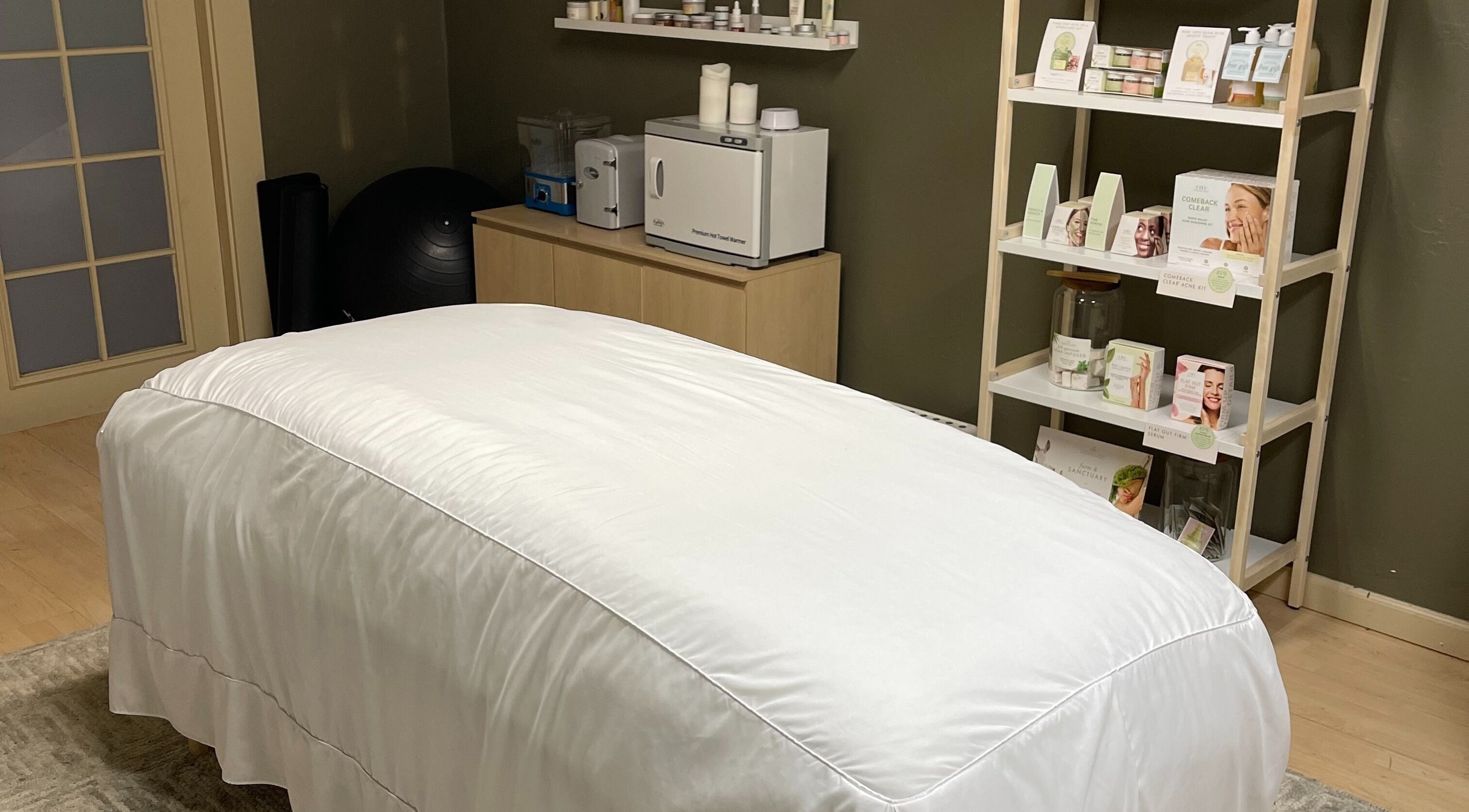 Calming massage room at The June Massage and Skin Studio in Monroe, Washington, US, featuring a treatment bed.