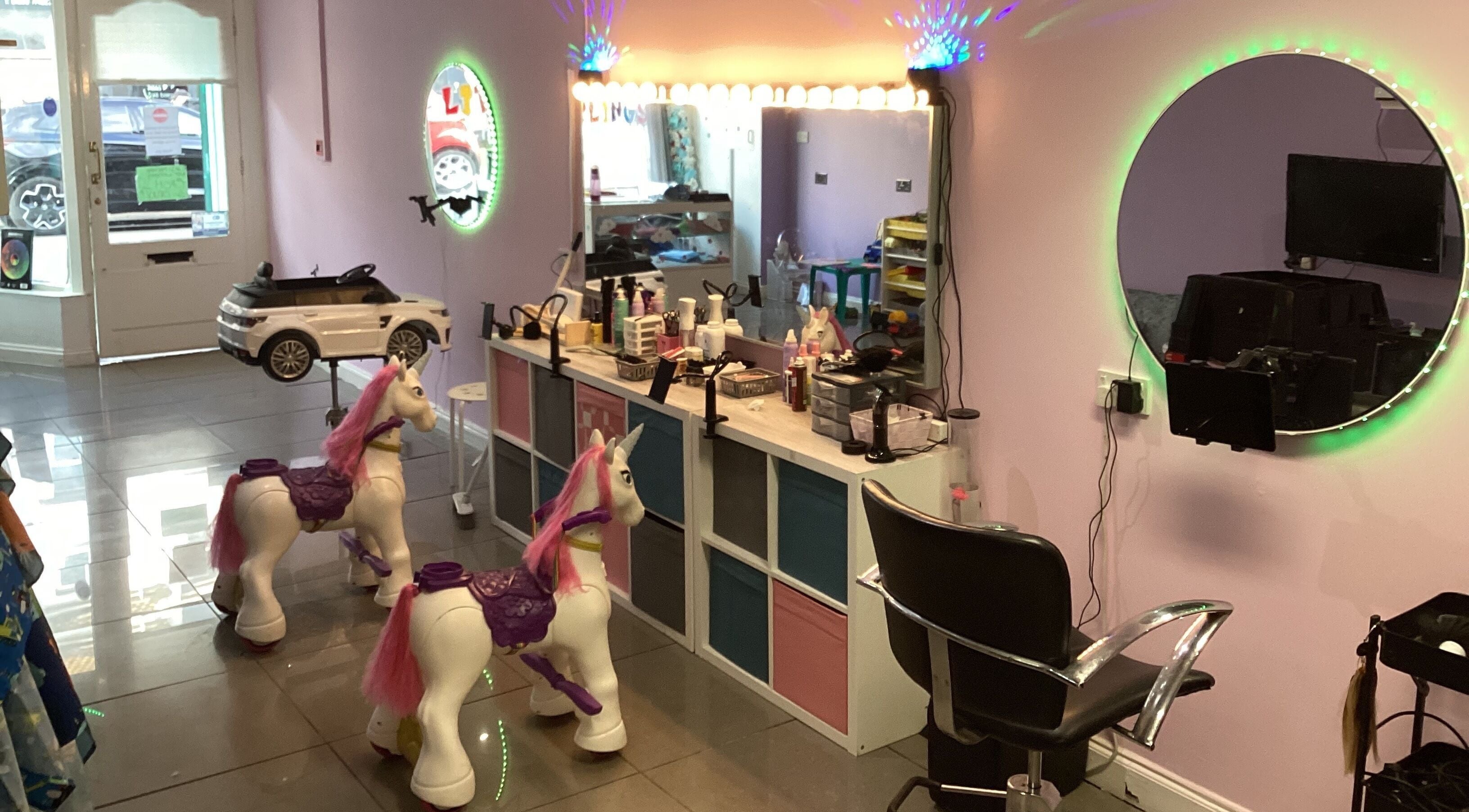Inside Little Darlings Childrens Hair Salon, Clacton-on-sea, England. Colorful child-friendly salon with unicorn chairs.