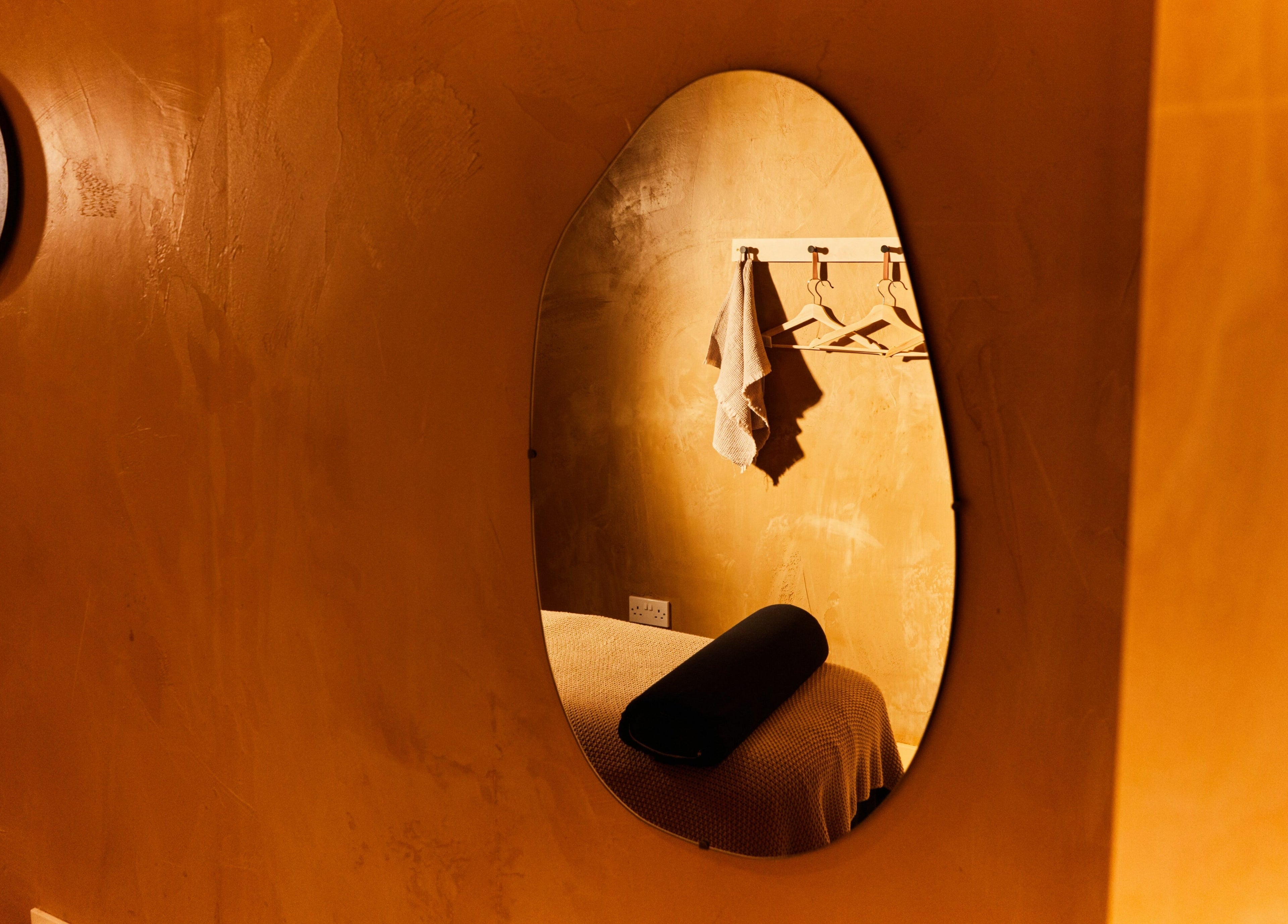 Cozy therapy room mirror at Bodied, London, England, GB reflecting a serene treatment ambiance.