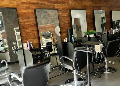 Modern salon interior at NEW by CARO RIBEIRO, South Miami, Florida, US showcasing sleek styling stations.