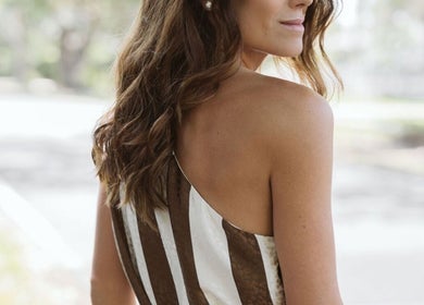 Woman with long brown hair in elegant attire at NEW by CARO RIBEIRO, South Miami, Florida, US